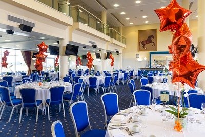 red star balloons and decorated tables at York Racecourse