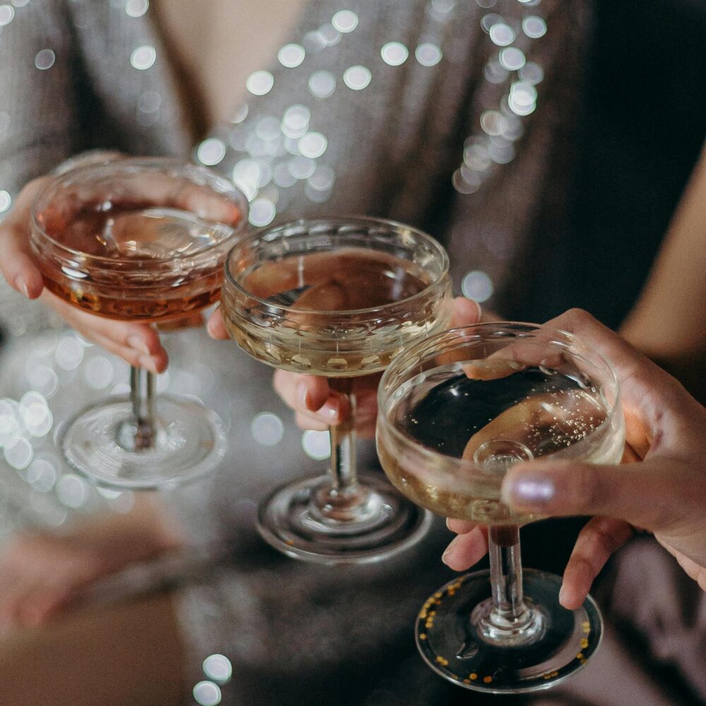 Christmas party guests holding champagne glasses