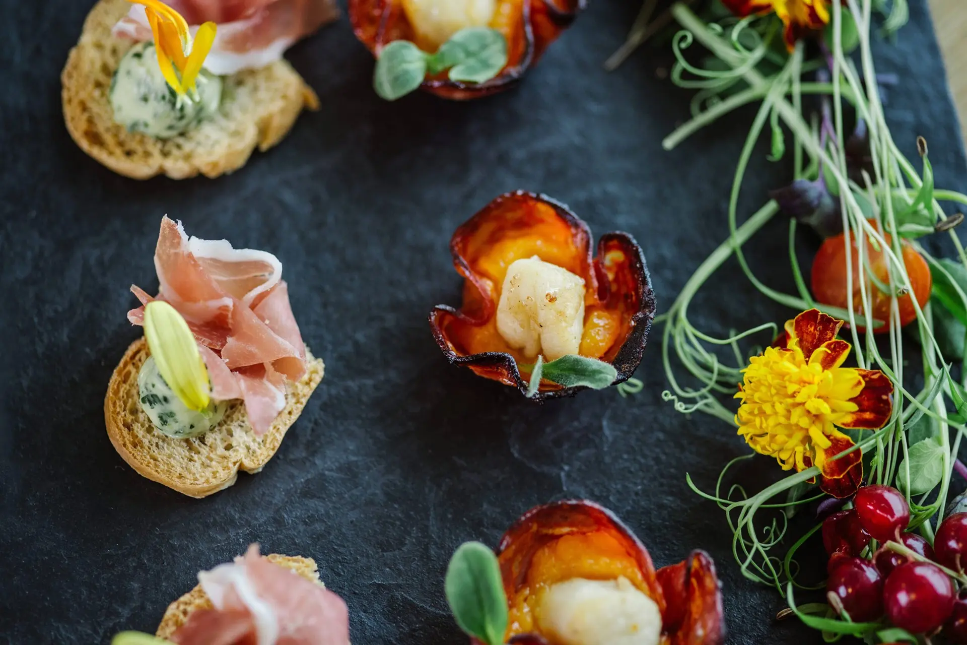 a clsoe up of canapes on a slate board