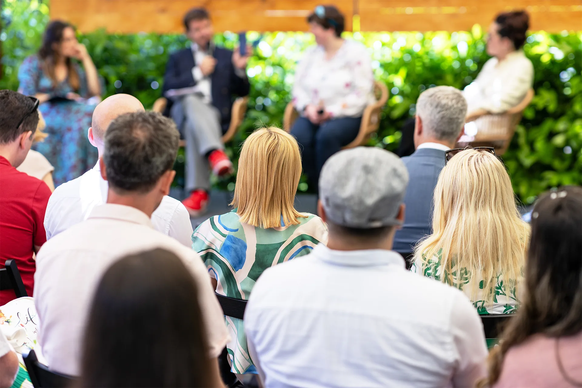 an outdoor conference talk surrounded by greenery